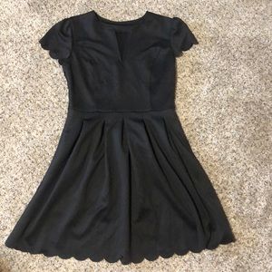Simple black cap sleeve dress with scallop edges